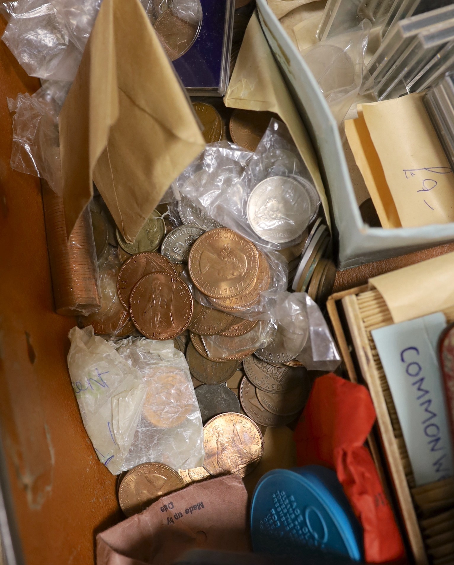 A collection of UK and Commonwealth coins and tokens 18th–20th century, the majority George VI onwards including commemorative crowns a 1974 coinage of Barbados set, a Victoria half Farthing etc . In a suitcase